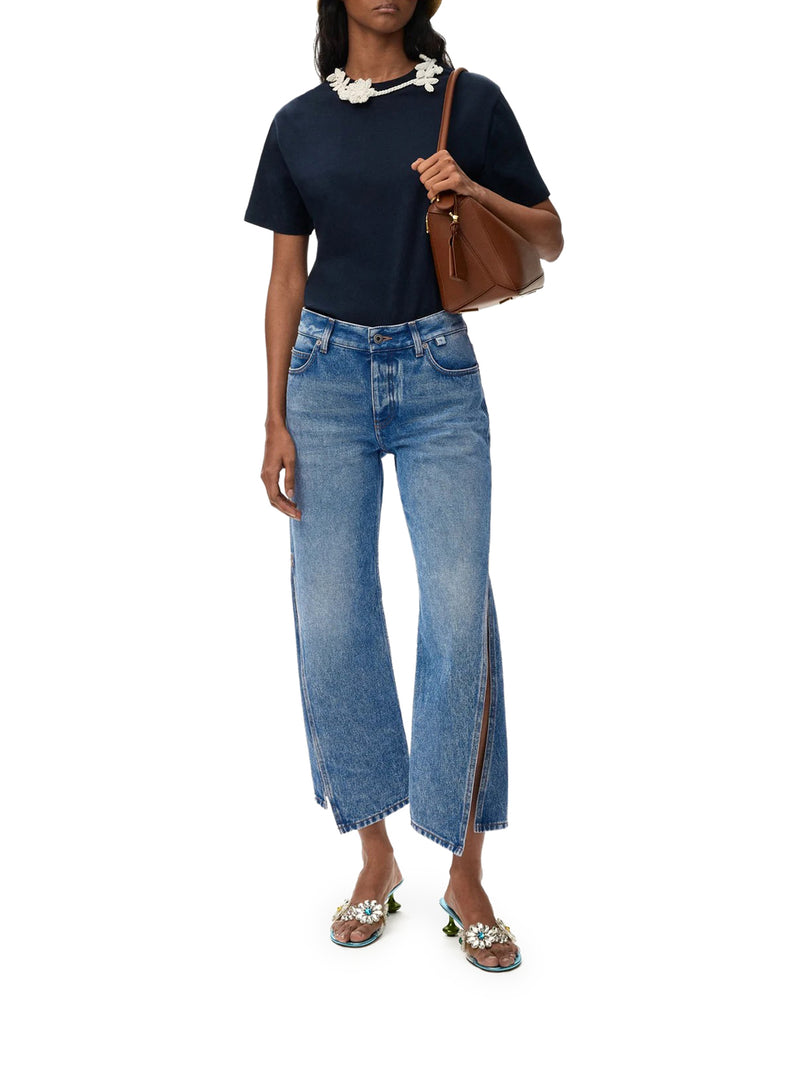 DENIM TROUSERS WITH FLARED LEG AND SIDE SLITS